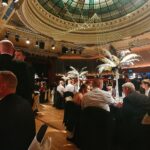 Wyre Business Awards at the Marine Hall Fleetwood with men in dinner suits and ladies in evening dress. Circular glass ceiling in greens. Circular dressed tables for the ceremony