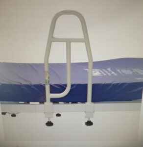 Grab rail fixed to a profiling bed to help guests into bed safely.